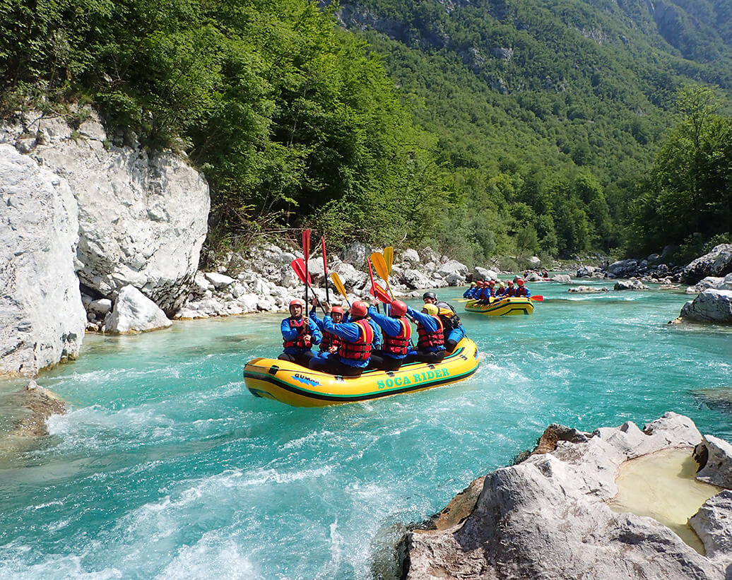 Whitewater rafting tour Bovec | Rafters are following High five! command on whitewater rafting tour in Bovec