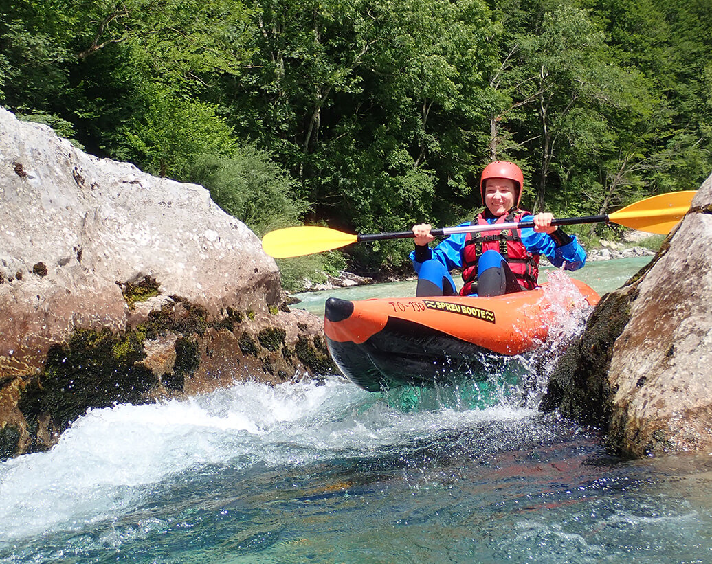 Whitewater kayaking Slovenia, Bovec, Soča | Whitewater kayaker is in a rapid of Soča river